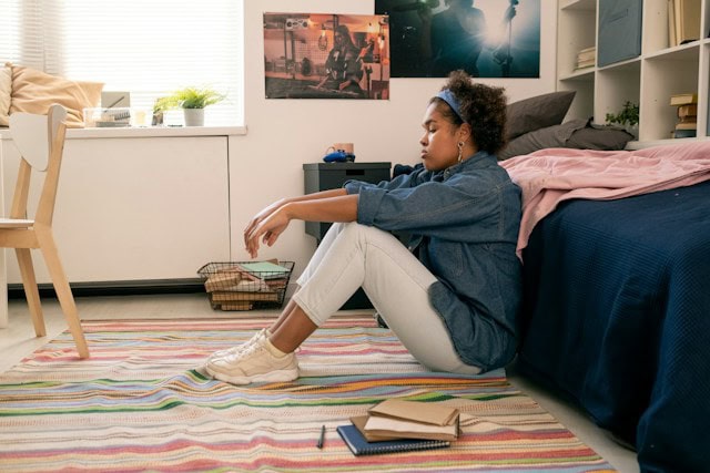 teenager sitting alone in room signs of depression in teens